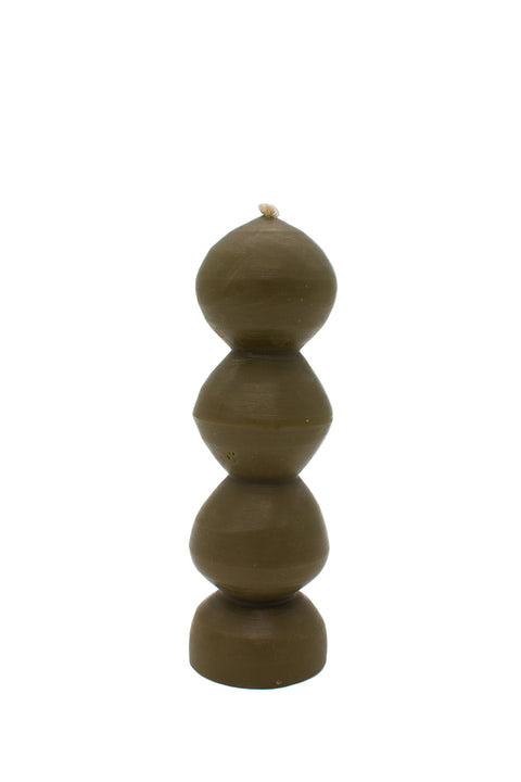 A sculptural, multi-tiered pillar candle made of olive green wax, featuring organic, rounded stacked shapes.