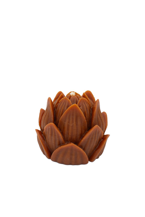 A brown lotus-shaped candle with textured, layered petals, photographed on a seamless light gray background.